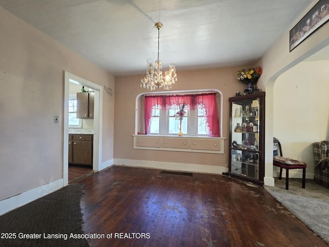 1045 N Larch St, Lansing, MI 48906 - unfurnished dining area with plenty of natural light, hardwood / wood-style flooring, baseboards, and a chandelier