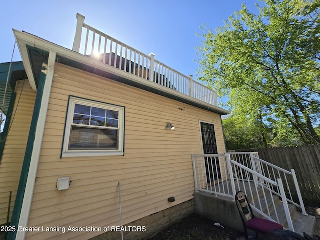 1045 N Larch St, Lansing, MI 48906 - view of side of property with a balcony and fence