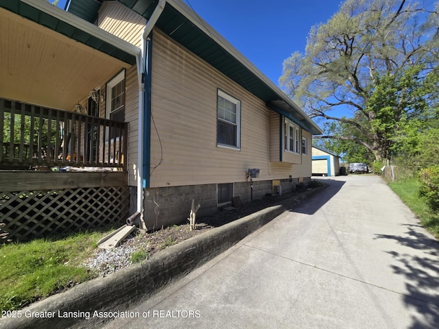 1045 N Larch St, Lansing, MI 48906 - view of home's exterior featuring an outdoor structure and a detached garage