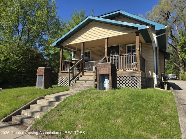 1045 N Larch St, Lansing, MI 48906 - view of front facade with a porch and a front lawn