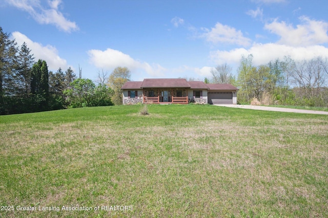 single story home with a garage, a front lawn, and concrete driveway