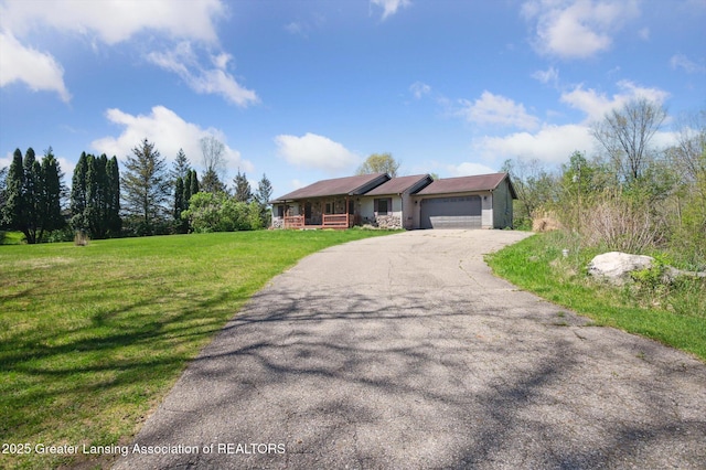 ranch-style house with asphalt driveway, a garage, a front yard, and a porch