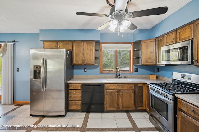 kitchen featuring stainless steel appliances, open shelves, a sink, and ceiling fan