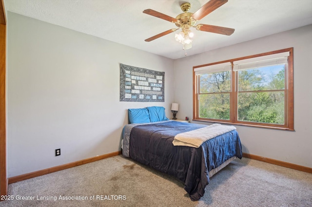 bedroom featuring carpet floors, baseboards, and a ceiling fan