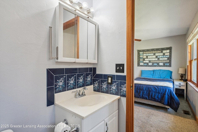 bathroom with vanity and ensuite bath