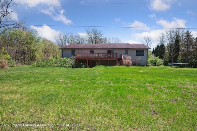 back of house featuring a deck and a yard