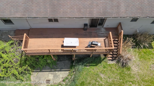 rear view of house featuring a wooden deck and roof with shingles