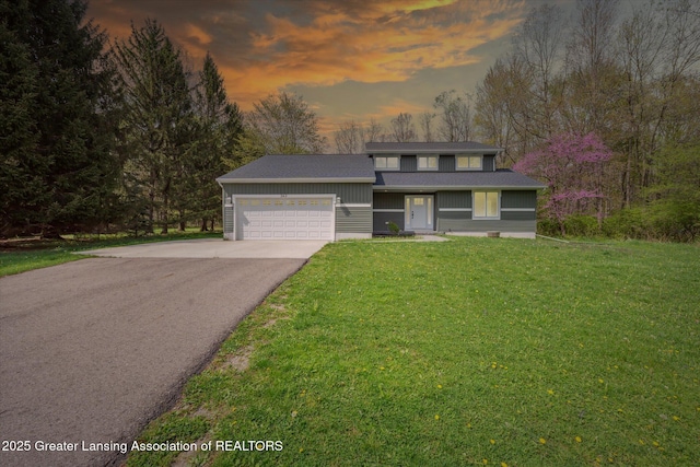 263 E Sherwood Rd, Williamston, MI 48895 - traditional-style house featuring driveway, a garage, and a front lawn