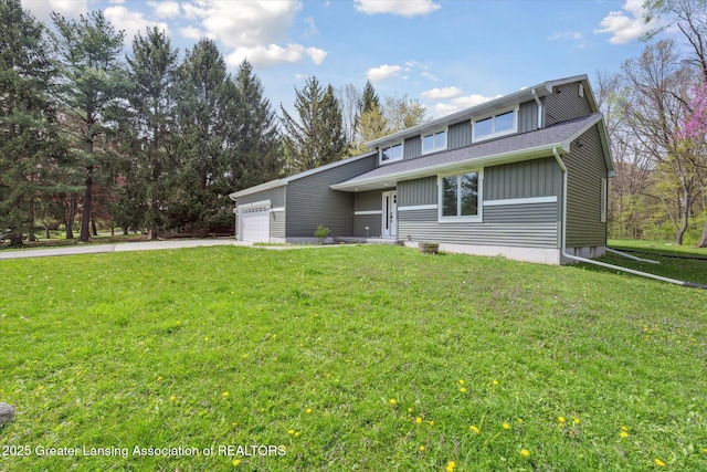 263 E Sherwood Rd, Williamston, MI 48895 - view of front facade with an attached garage, a front lawn, and concrete driveway