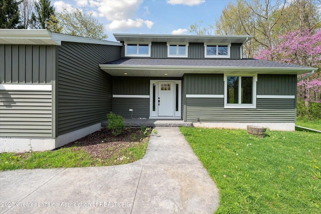 263 E Sherwood Rd, Williamston, MI 48895 - view of front of property with a front yard and board and batten siding