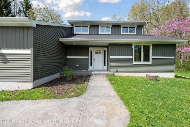 263 E Sherwood Rd, Williamston, MI 48895 - view of front of property featuring a front lawn and board and batten siding