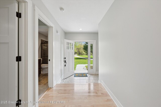 263 E Sherwood Rd, Williamston, MI 48895 - foyer entrance with light wood-style flooring and baseboards