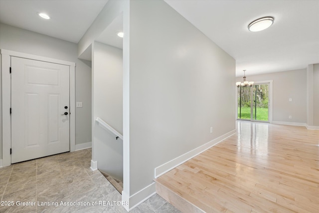 263 E Sherwood Rd, Williamston, MI 48895 - hallway featuring a chandelier, baseboards, recessed lighting, and light wood finished floors