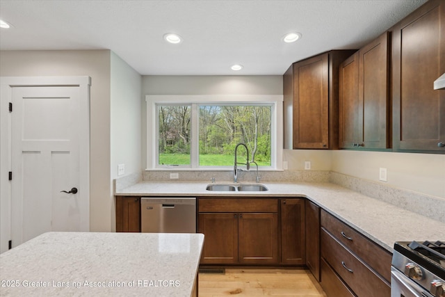 263 E Sherwood Rd, Williamston, MI 48895 - kitchen featuring stainless steel appliances, a sink, light countertops, light wood-style flooring, and recessed lighting
