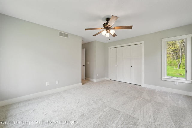 263 E Sherwood Rd, Williamston, MI 48895 - unfurnished bedroom featuring baseboards, carpet, a closet, and a ceiling fan