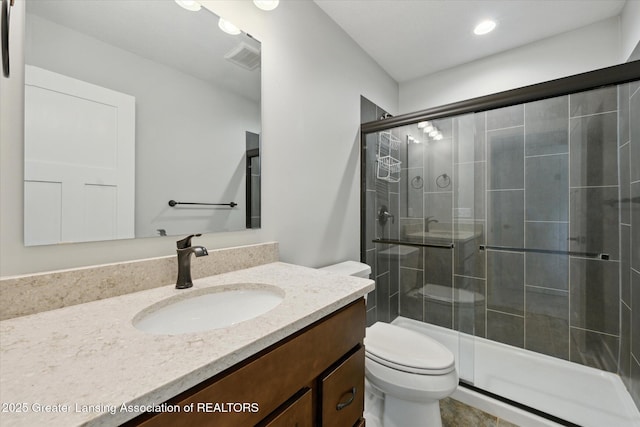 263 E Sherwood Rd, Williamston, MI 48895 - full bath featuring toilet, a shower stall, vanity, and recessed lighting