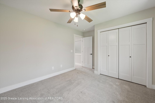 263 E Sherwood Rd, Williamston, MI 48895 - unfurnished bedroom featuring carpet floors, baseboards, a closet, and a ceiling fan