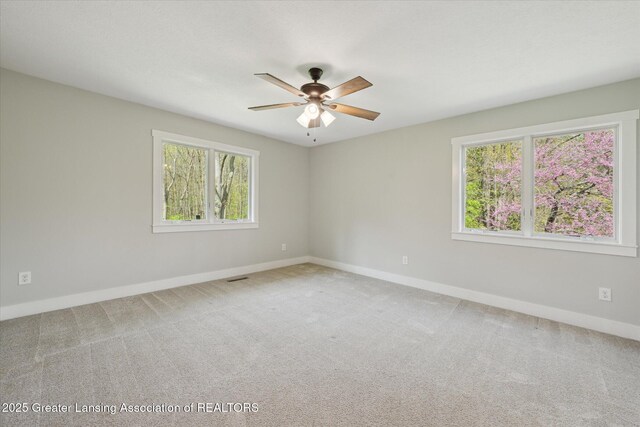 263 E Sherwood Rd, Williamston, MI 48895 - carpeted empty room with plenty of natural light, a ceiling fan, and baseboards