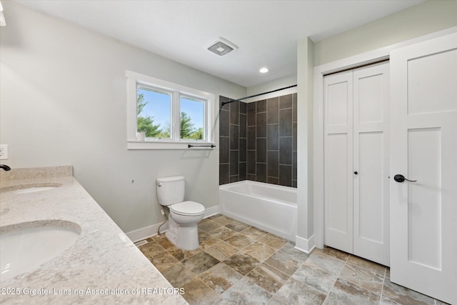 263 E Sherwood Rd, Williamston, MI 48895 - bathroom featuring baseboards, toilet, double vanity, recessed lighting, and shower / bathtub combination