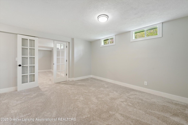 263 E Sherwood Rd, Williamston, MI 48895 - below grade area with french doors, carpet, a textured ceiling, and baseboards