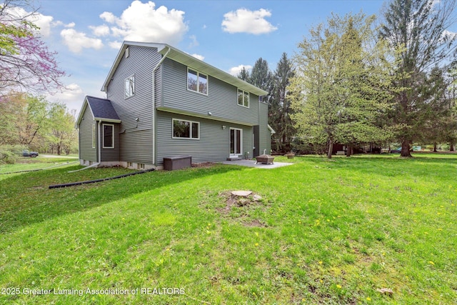 263 E Sherwood Rd, Williamston, MI 48895 - rear view of property featuring a lawn and an outdoor fire pit