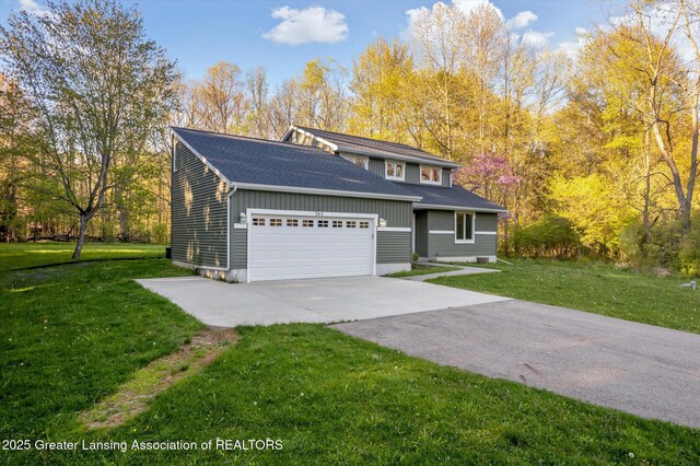 263 E Sherwood Rd, Williamston, MI 48895 - view of front of house with a garage, a front yard, concrete driveway, and roof with shingles