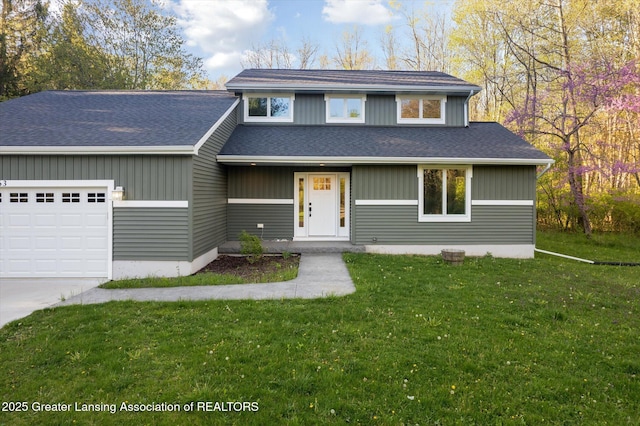 263 E Sherwood Rd, Williamston, MI 48895 - view of front of property featuring a garage, a front yard, a shingled roof, and driveway