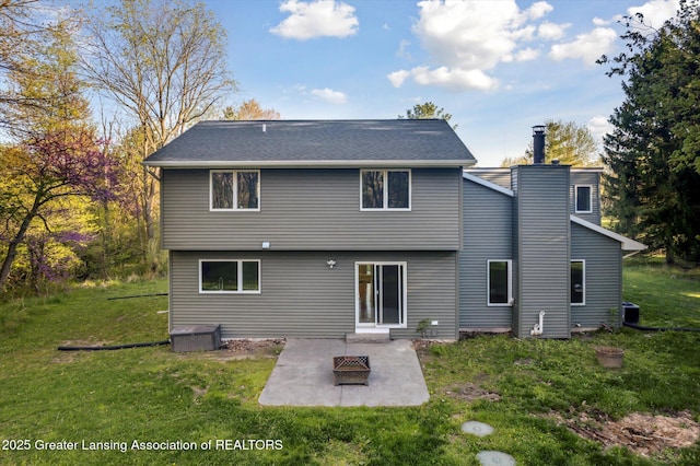 263 E Sherwood Rd, Williamston, MI 48895 - rear view of house with a patio, a yard, a chimney, and cooling unit