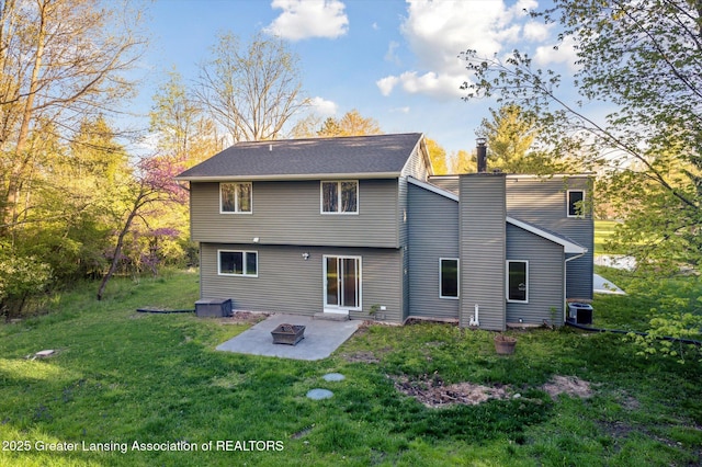 263 E Sherwood Rd, Williamston, MI 48895 - back of house featuring central AC, a patio, a yard, and an outdoor fire pit