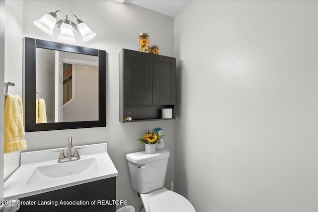 half bath featuring toilet and vanity