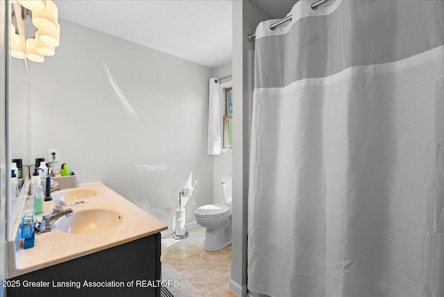bathroom with toilet, double vanity, and curtained shower