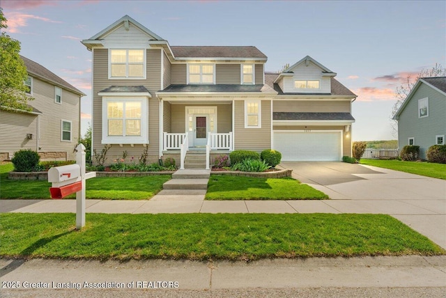 3837 Plover Pl, East Lansing, MI 48823 - view of front of property featuring a porch, driveway, a garage, and a lawn