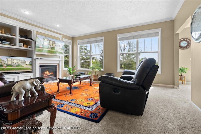 3837 Plover Pl, East Lansing, MI 48823 - living room with crown molding, a glass covered fireplace, a textured ceiling, carpet flooring, and baseboards