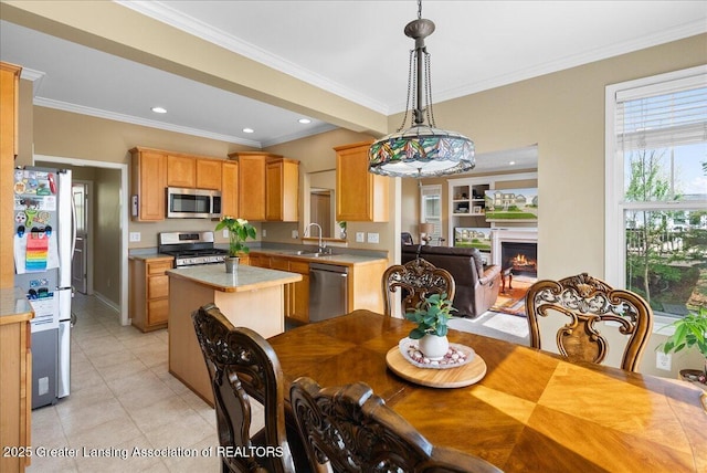 3837 Plover Pl, East Lansing, MI 48823 - dining area with light tile patterned floors, crown molding, a warm lit fireplace, and recessed lighting