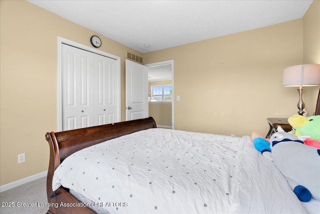 3837 Plover Pl, East Lansing, MI 48823 - bedroom with baseboards, a closet, and carpet floors