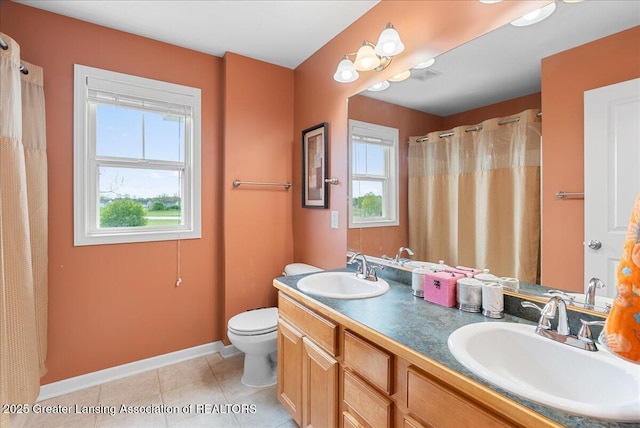 3837 Plover Pl, East Lansing, MI 48823 - full bath featuring baseboards, tile patterned floors, toilet, double vanity, and curtained shower