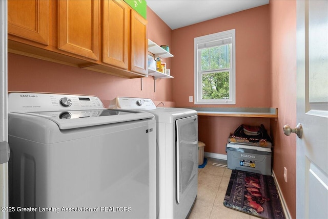 3837 Plover Pl, East Lansing, MI 48823 - washroom with washer and dryer, cabinet space, light tile patterned flooring, and baseboards
