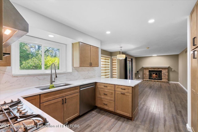 1263 Leeward Dr, Okemos, MI 48864 - kitchen with dishwasher, a sink, a peninsula, wood finished floors, and open floor plan