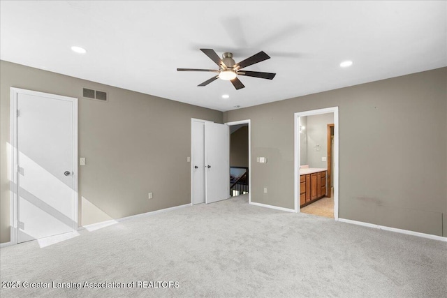 1263 Leeward Dr, Okemos, MI 48864 - unfurnished bedroom featuring light colored carpet, baseboards, recessed lighting, ensuite bath, and ceiling fan
