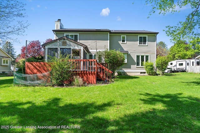 1263 Leeward Dr, Okemos, MI 48864 - back of property with a chimney, a yard, a deck, and stairs
