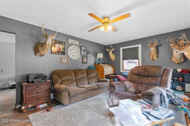 10111 Kinneville Rd, Eaton Rapids, MI 48827 - living room with wood finished floors, a ceiling fan, and a textured ceiling