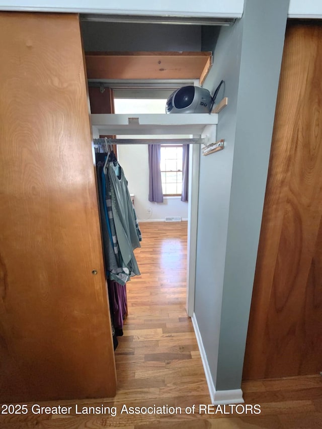 1048 Chris J Dr, Lansing, MI 48917 - hall featuring wood finished floors and baseboards