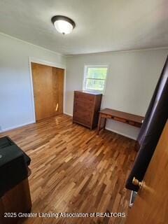 1048 Chris J Dr, Lansing, MI 48917 - unfurnished bedroom featuring wood finished floors and a closet