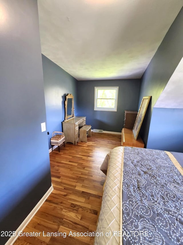 1048 Chris J Dr, Lansing, MI 48917 - bedroom with baseboards and wood finished floors