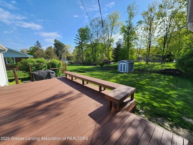 1048 Chris J Dr, Lansing, MI 48917 - wooden deck featuring a storage shed, an outdoor structure, grilling area, and view of wooded area