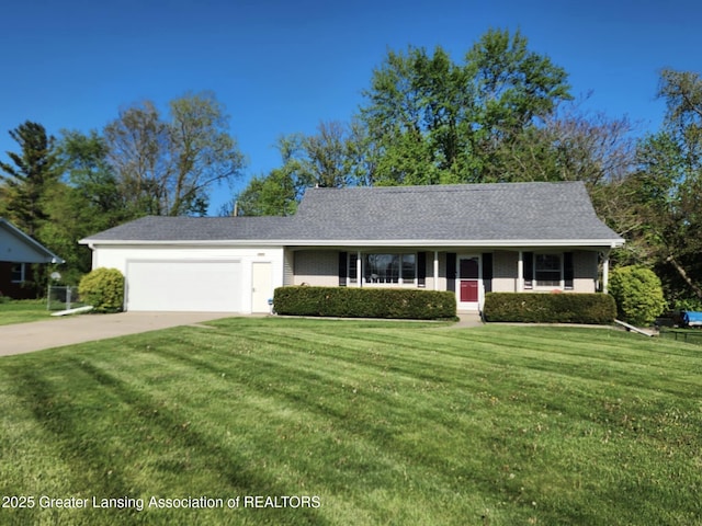 1048 Chris J Dr, Lansing, MI 48917 - view of front facade with driveway, an attached garage, and a front yard