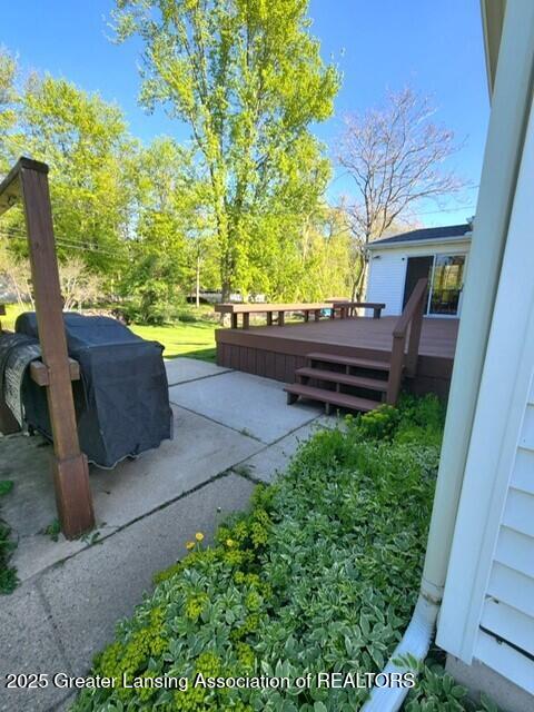 1048 Chris J Dr, Lansing, MI 48917 - view of patio with a deck