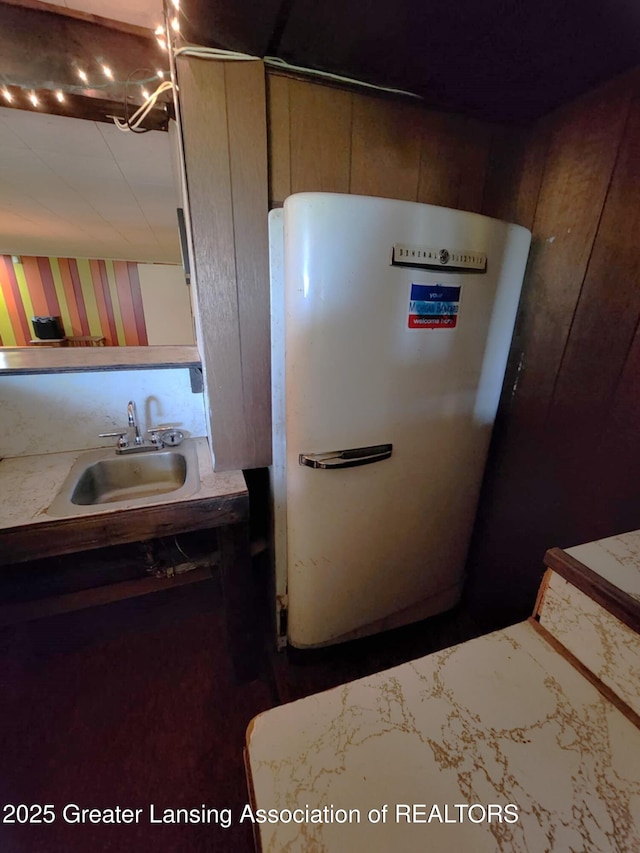 1048 Chris J Dr, Lansing, MI 48917 - detailed view of a sink and refrigerator