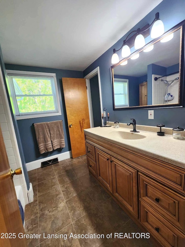 1048 Chris J Dr, Lansing, MI 48917 - bathroom with vanity, tile patterned floors, and baseboards