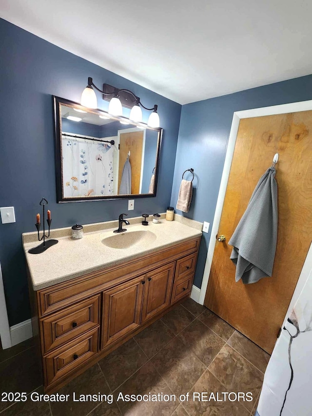 1048 Chris J Dr, Lansing, MI 48917 - full bath with vanity, baseboards, and tile patterned floors